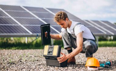 Technician performing solar panel repair on a residential rooftop system.